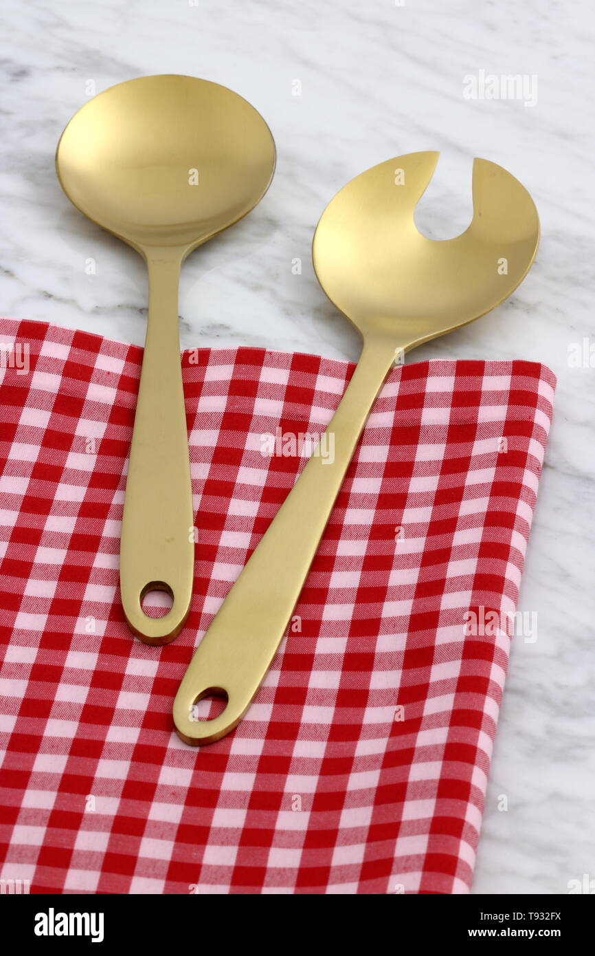 trendy and beautiful golden serving spoon and fork set styled on