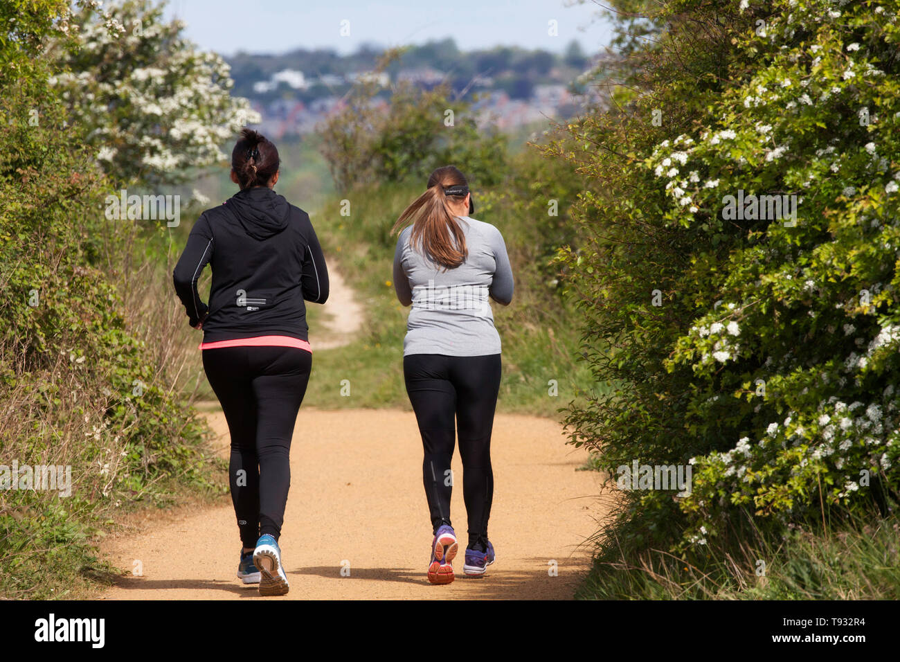 Two female joggers on the Hayling Billy Trail, Hayling Island, UK Stock Photo