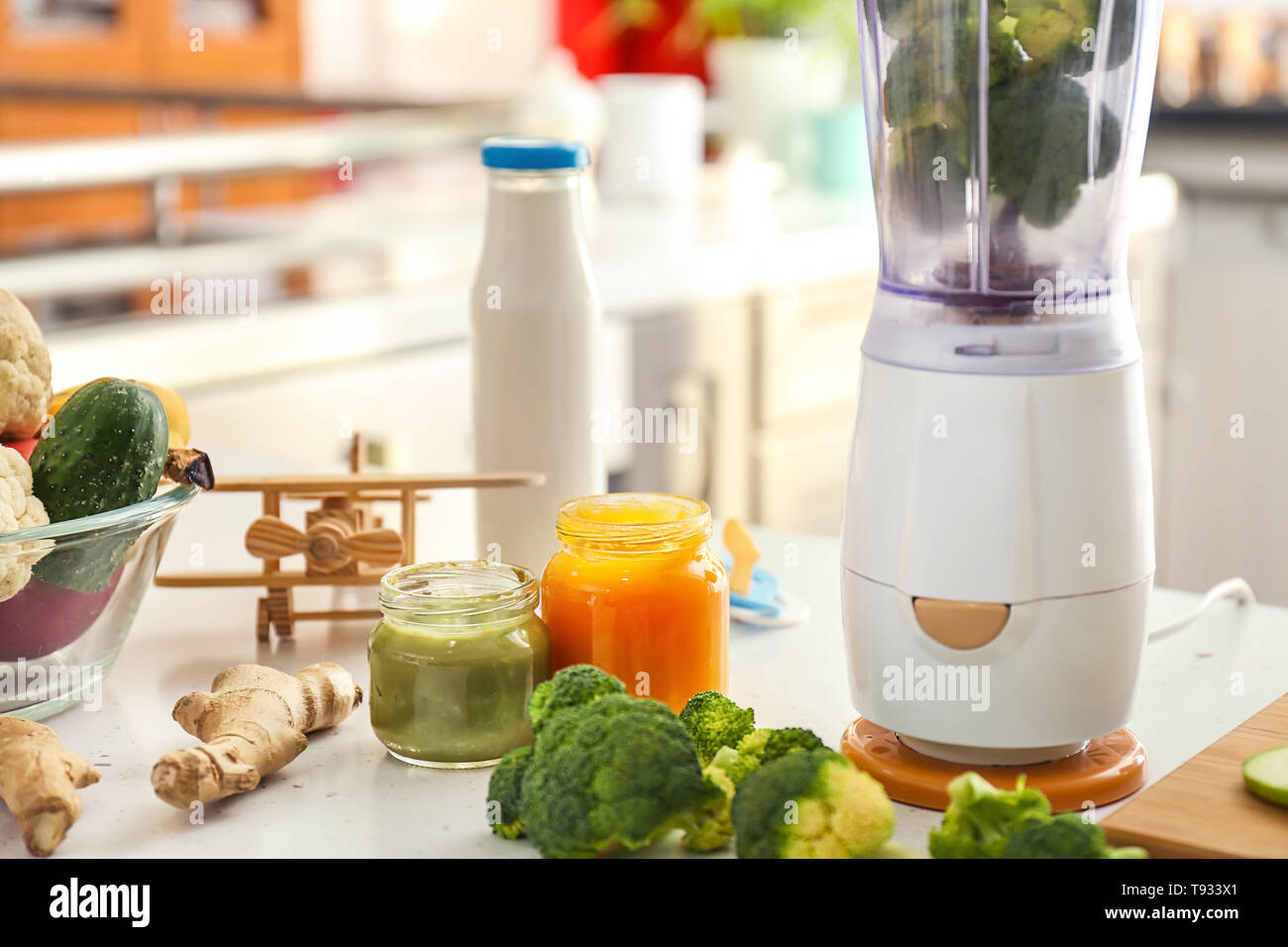 Blender and ingredients for baby food on kitchen table Stock Photo