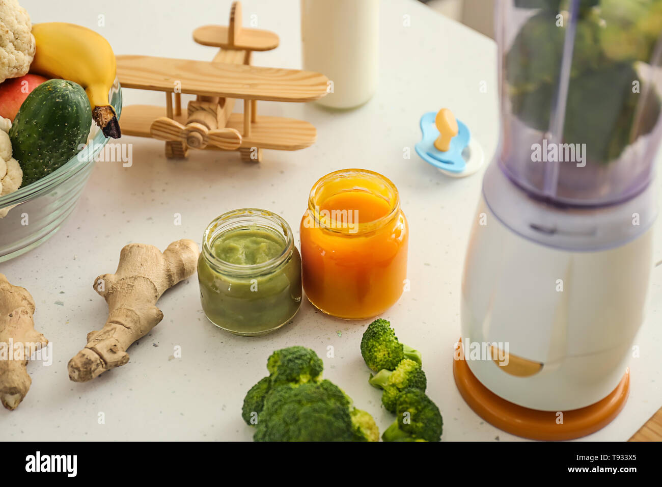 Blender and ingredients for baby food on kitchen table Stock Photo