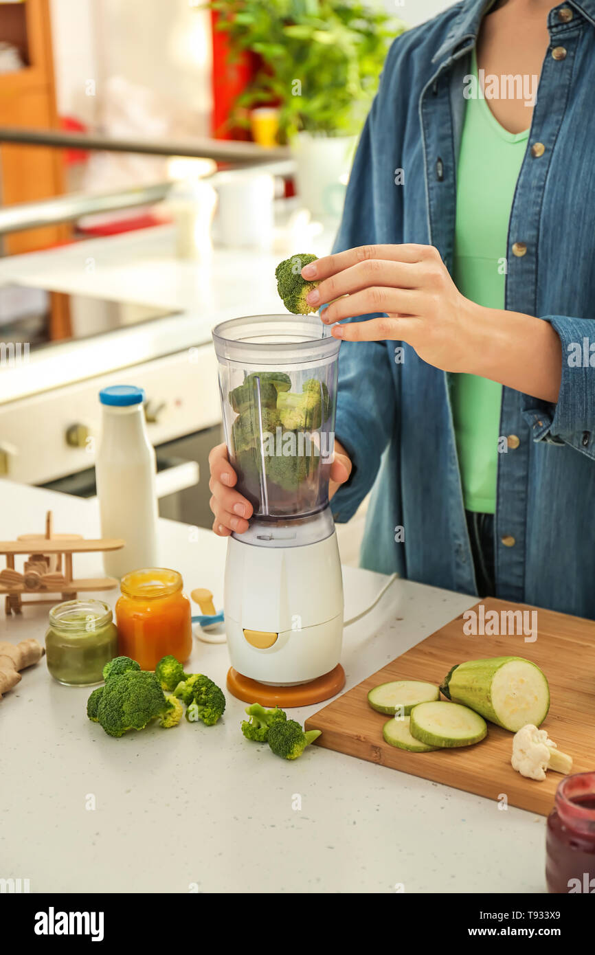 Woman preparing healthy baby food in kitchen Stock Photo