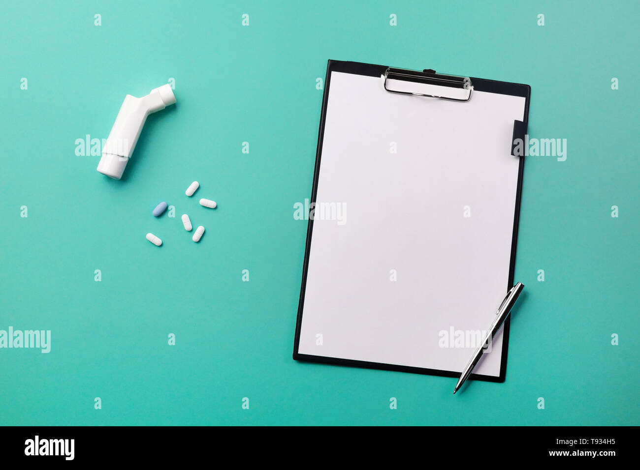 Doctors desk with tablet, pen, inhaler and pills. Top view with place for your text Stock Photo
