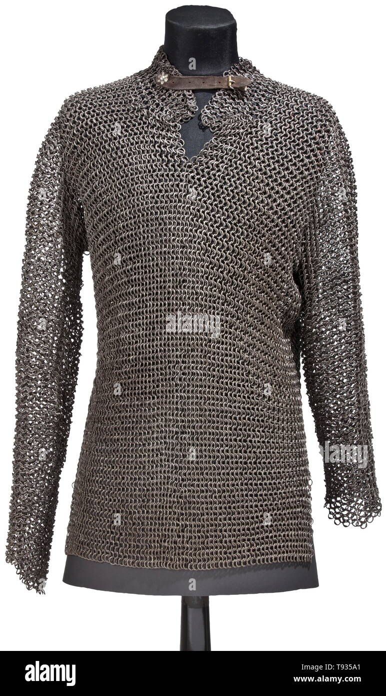 A Southeast European mail shirt, 16th/17th century Hip-length hauberk with long sleeves, neck opening and a short slit on each side. Heavy mesh consisting of alternating rows of closed and riveted rings with a round and flat cross-section, respectively. Leather fastening of later date at the neck. Hauberk in very good condition, no visible flaws. Length approximately 72 cm. historic, historical, 17th century, Additional-Rights-Clearance-Info-Not-Available Stock Photo