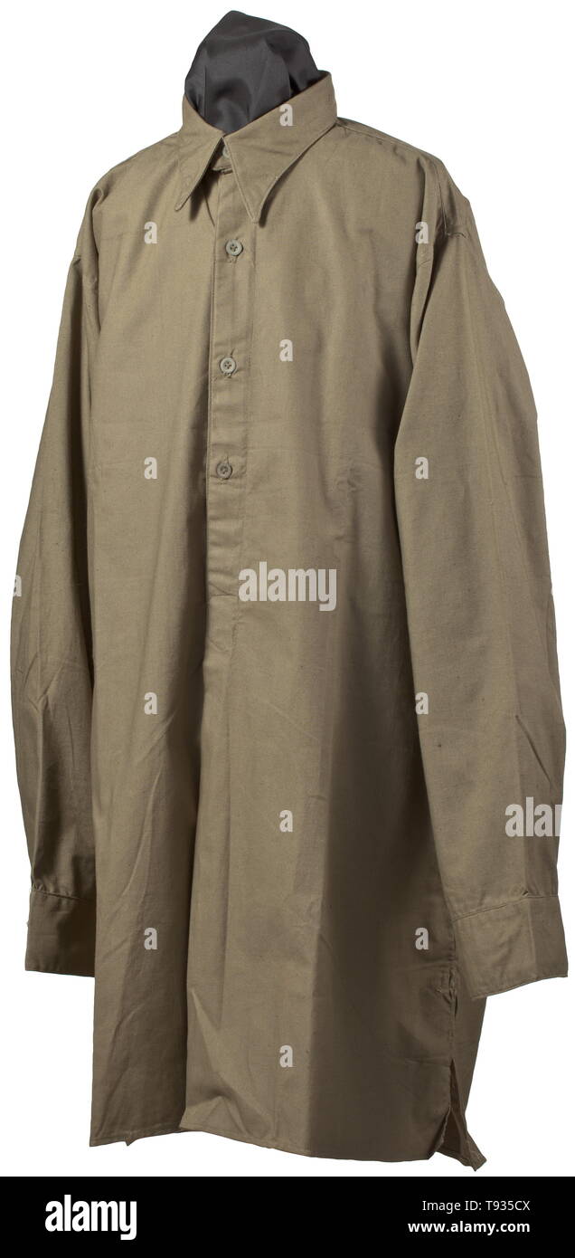 A tropical shirt for army members Olive-coloured cotton cloth with partial continuous button fly and olive-coloured paperboard buttons, in the collar a white (size?) stamping '42'. Absolutely colour-fresh and never worn. historic, historical, 20th century, Additional-Rights-Clearance-Info-Not-Available Stock Photo