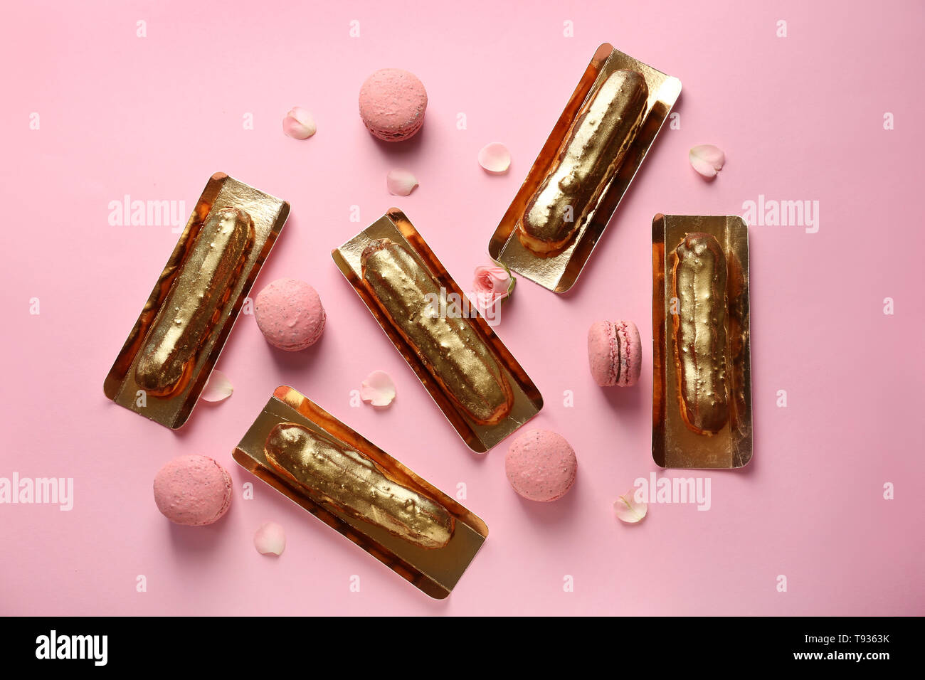 Flat lay composition with delicious eclairs on color background Stock Photo
