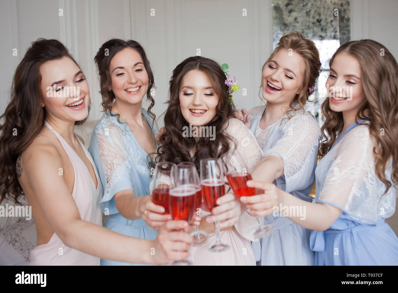 Cheerful Young Girlfriends Raise A Toast And Clink Glasses Birthday Party Or Bachelorette Party Pink Sparkling Wine Stock Photo Alamy