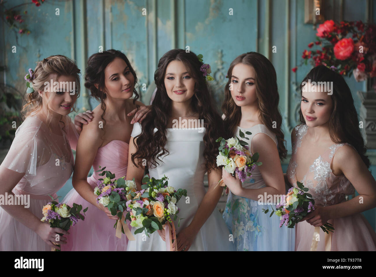 Bride and bridesmaids. Beautiful young women in dresses and with ...
