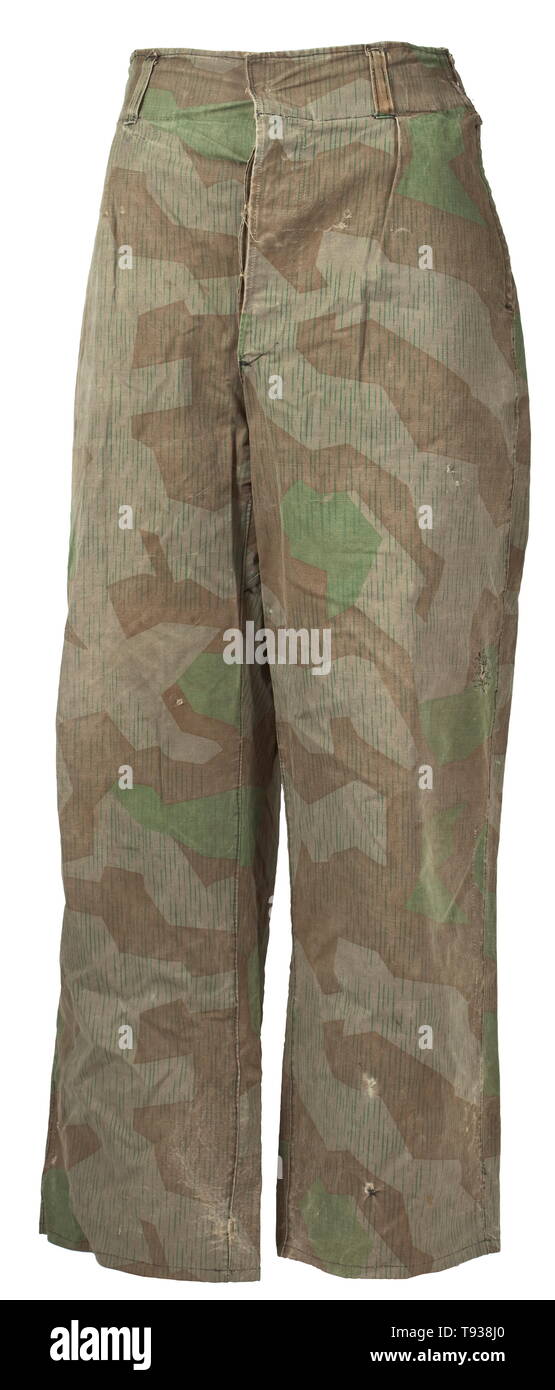 Trousers in splinter camouflage Front-produced from tent cloth, with covered fly, five belt loops and two pockets at the side seams. Clearly used with repaired areas. historic, historical, 20th century, Editorial-Use-Only Stock Photo