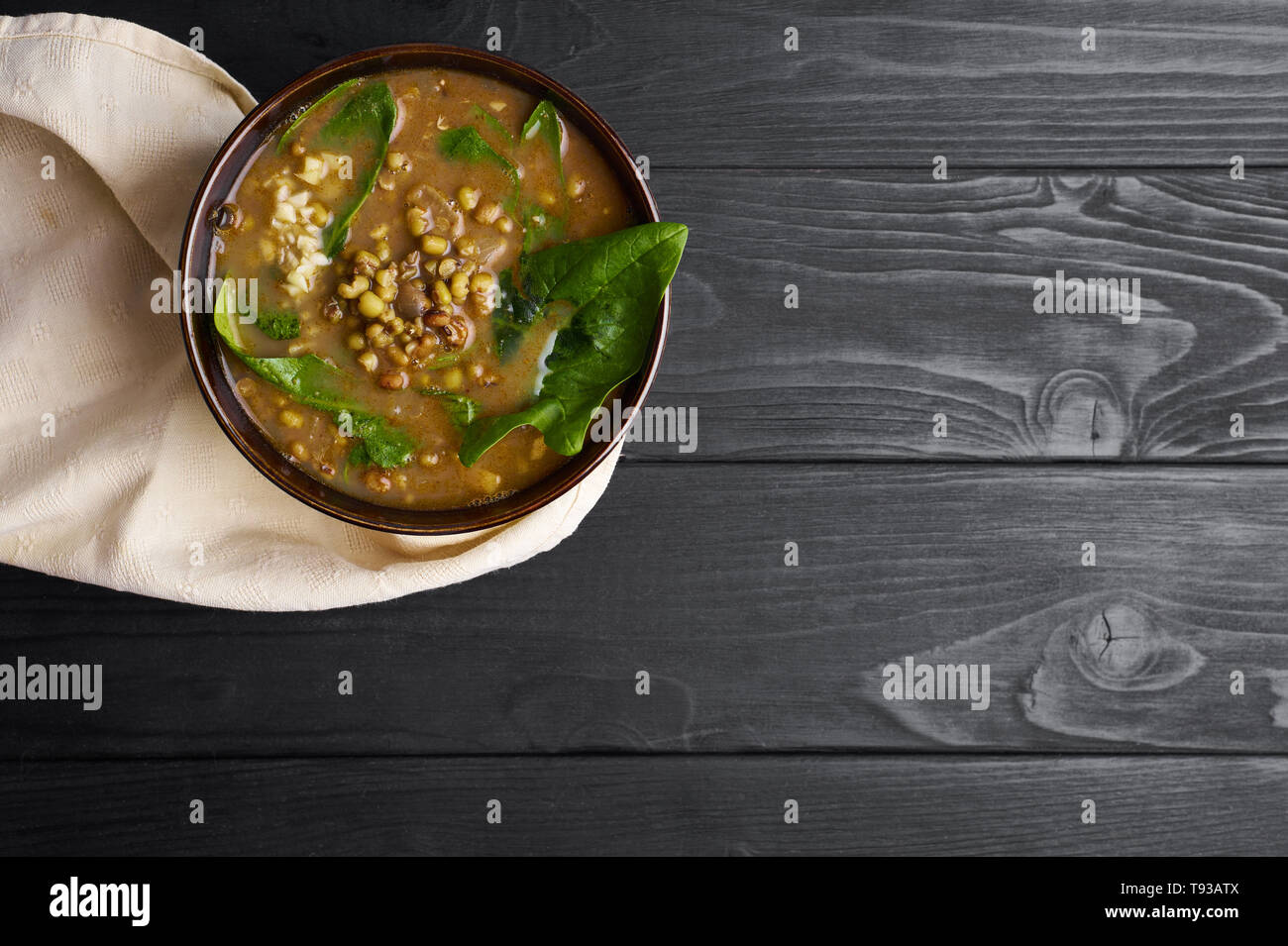 Mung Dhal with green spinach at black wooden tabletop. Moong Dal ...