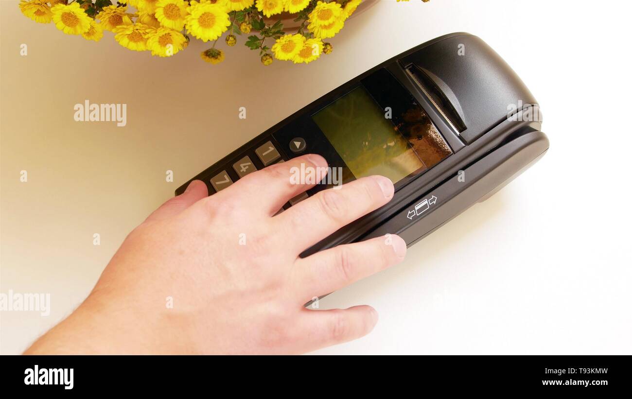 Payment terminal - a finger entering the PIN code Stock Photo - Alamy