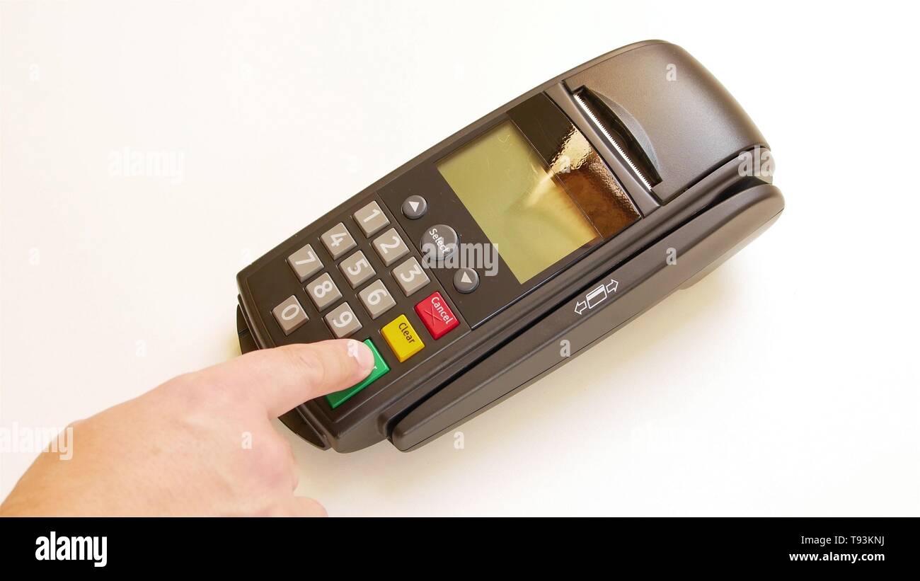 Payment terminal - a finger entering the PIN code Stock Photo - Alamy
