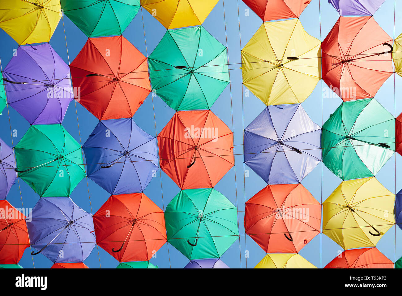 The image of colorful umbrellas on a background of blue sky Stock Photo