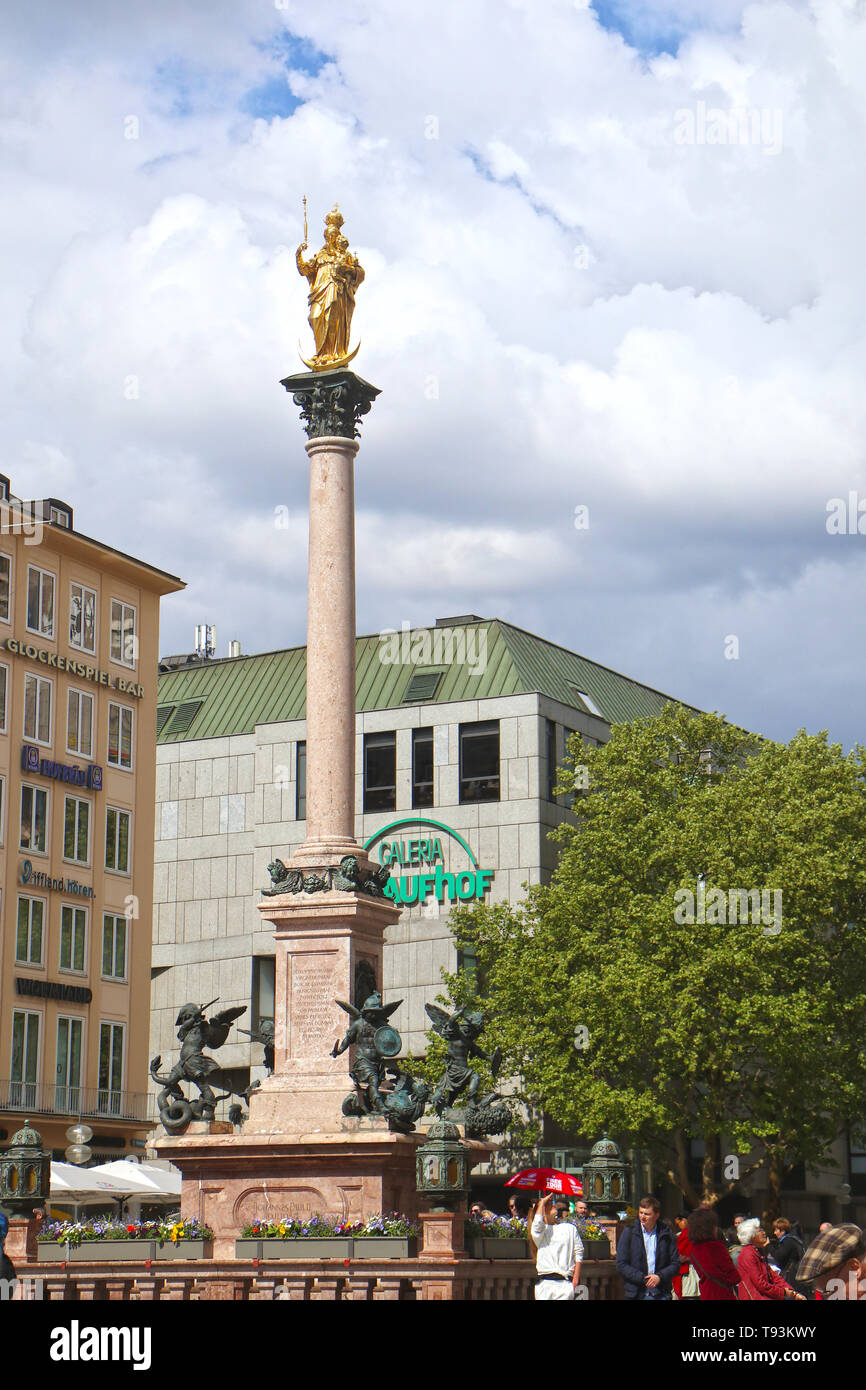 MUNICH, GERMANY - Mariensaeule, the golden holy Mary statue on a column erected in 1638 at Marienplatz in Munich, landmark and meeting point Stock Photo