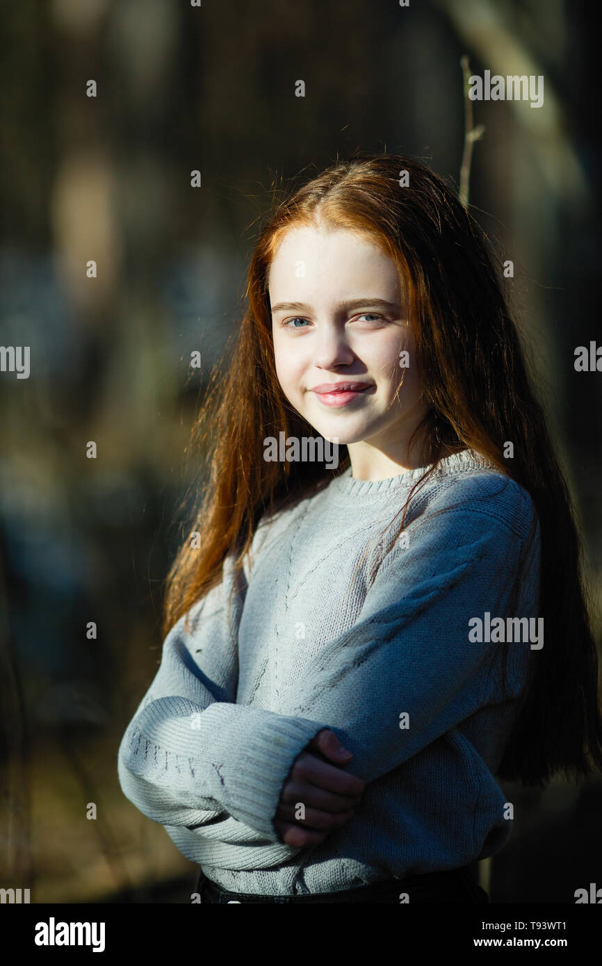 Cute Teen Girl With Long Bright Red Hair Closeup Portrait Outdoors