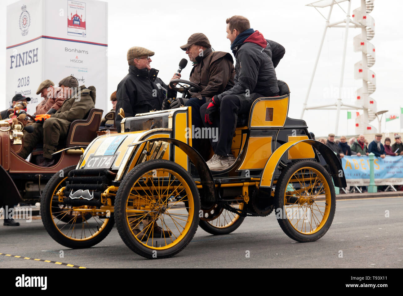 Mr Robert Hadfield in his 1901 Pick, being interviewed at the end of the 2018 London to Brighton Veteran Car Run Stock Photo