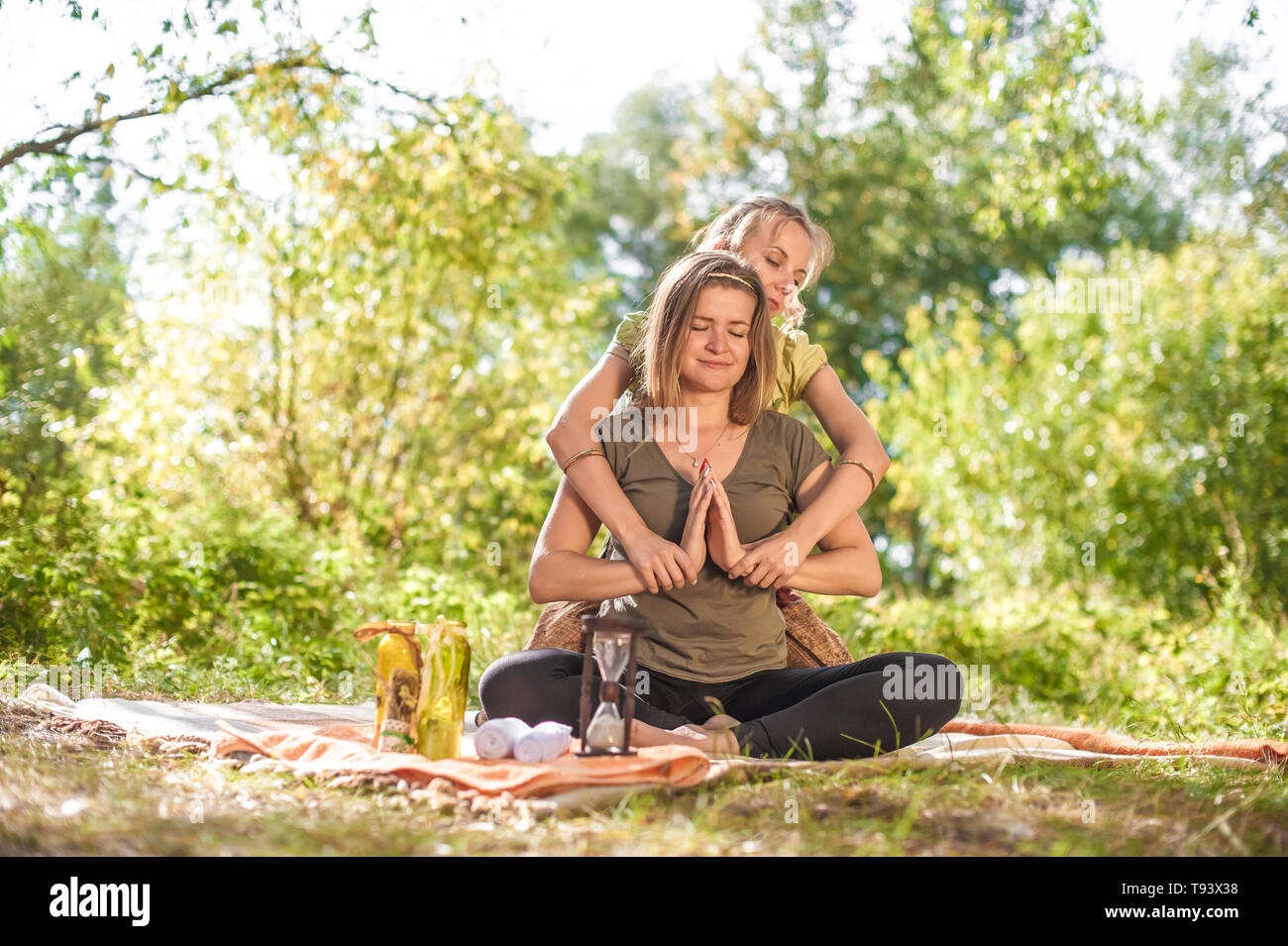 Girl on massage in nature with massage therapist. Stock Photo