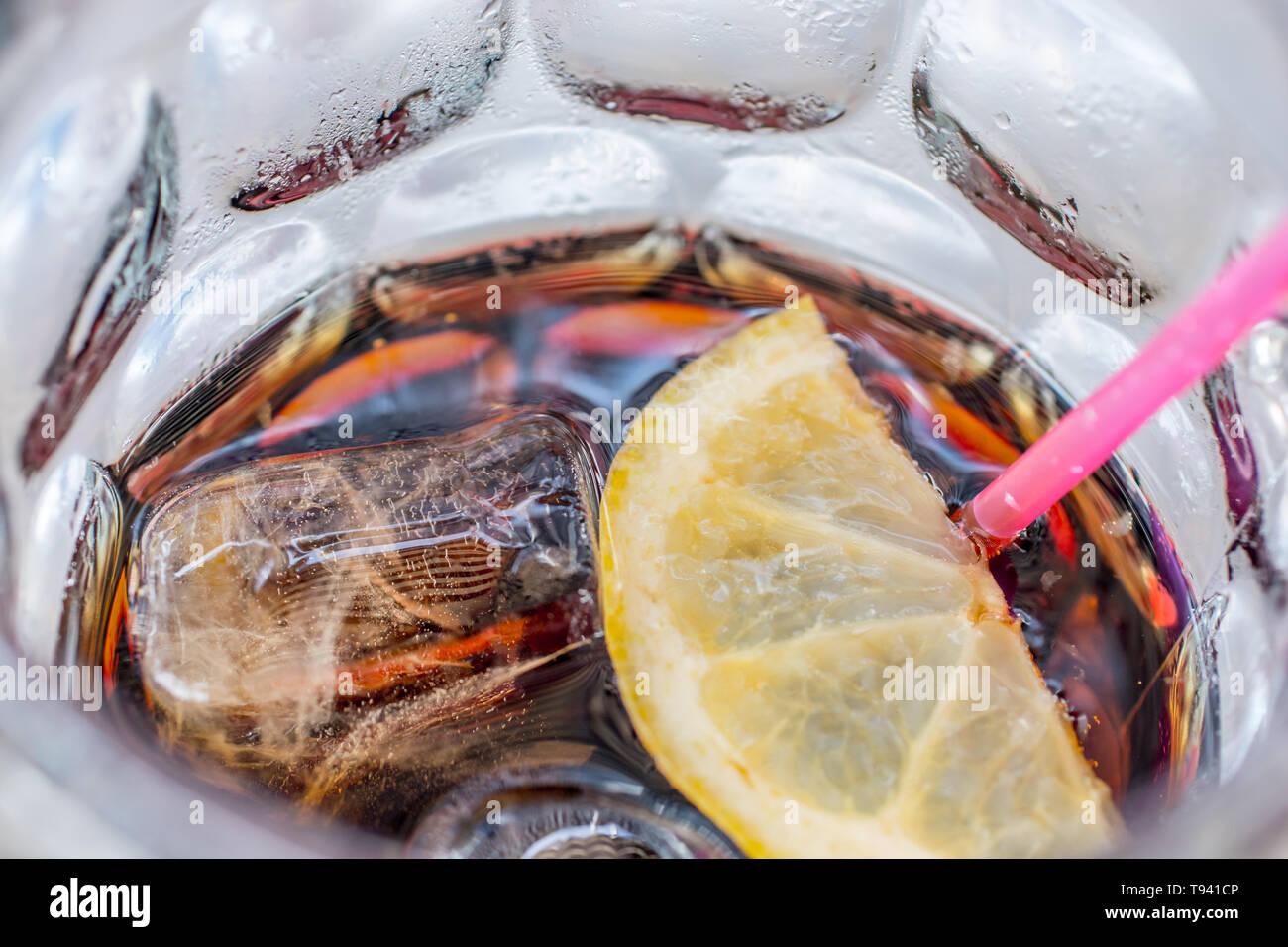 Glass of cola served with ice cubes slice of lemon and straw Stock ...