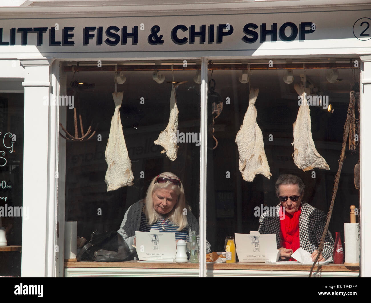Customers dine in the Little Fish & Chip Shop in Southwold Stock Photo