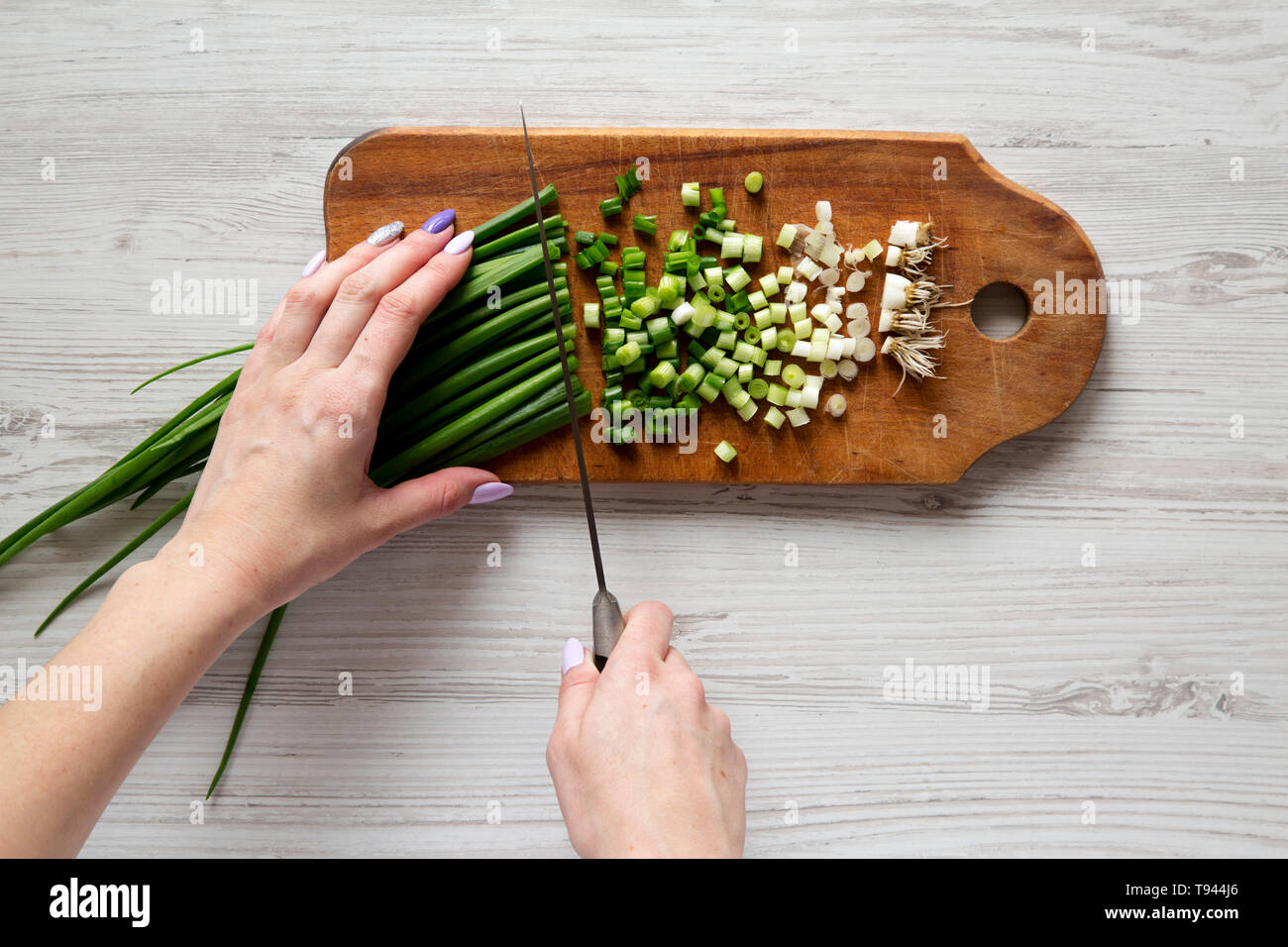 Woman chopping green onions, top view. Overhead, from above Stock Photo ...