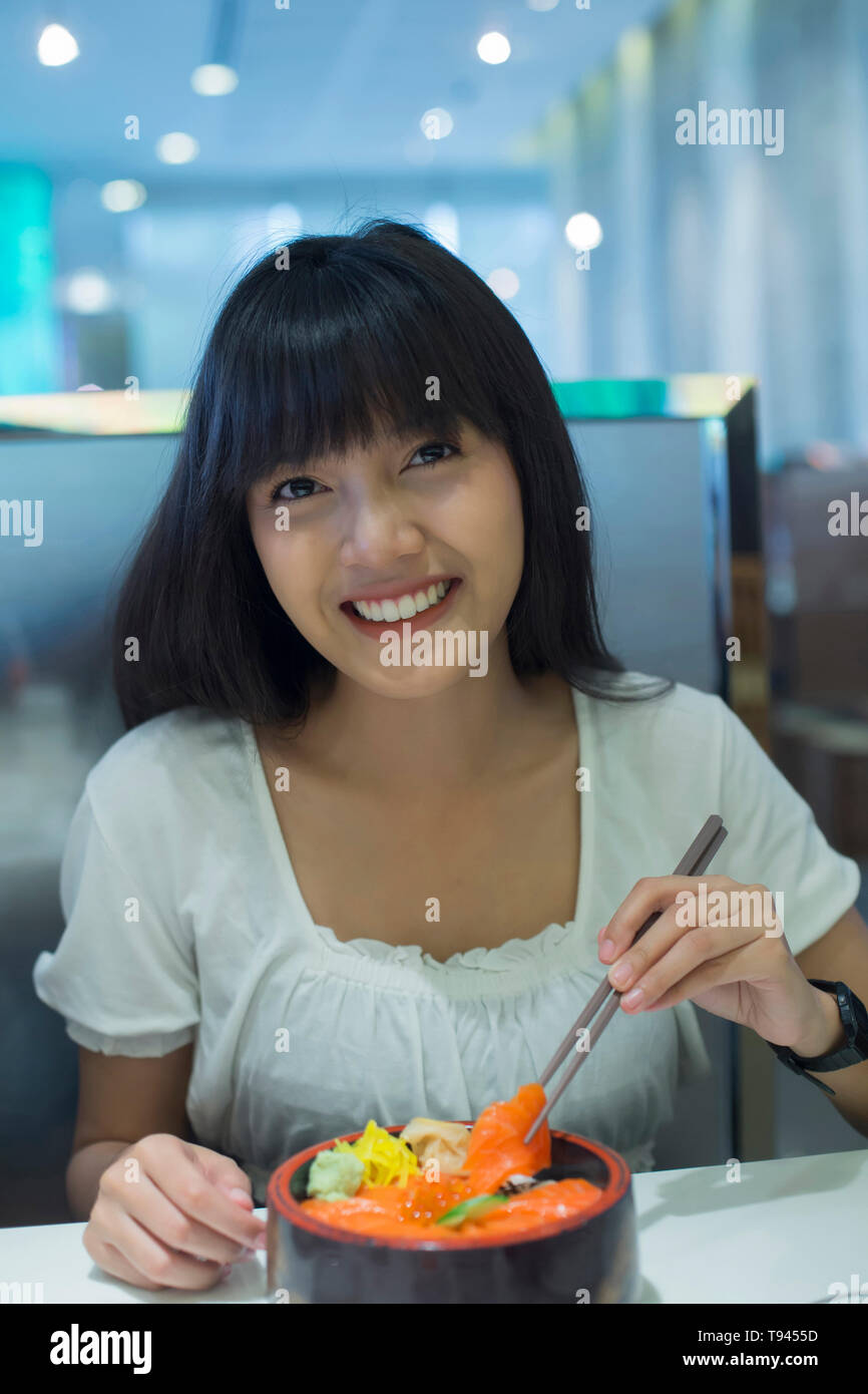 Asian girl eating rice hi-res stock photography and images - Alamy