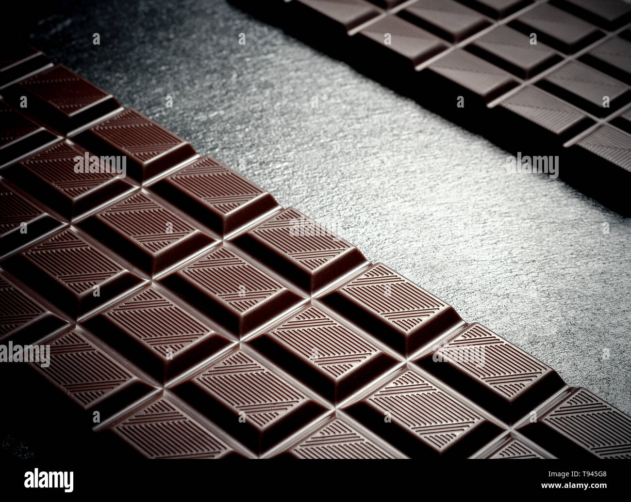 Black Chocolate Bar On Black Slate Plate Top View Stock Photo