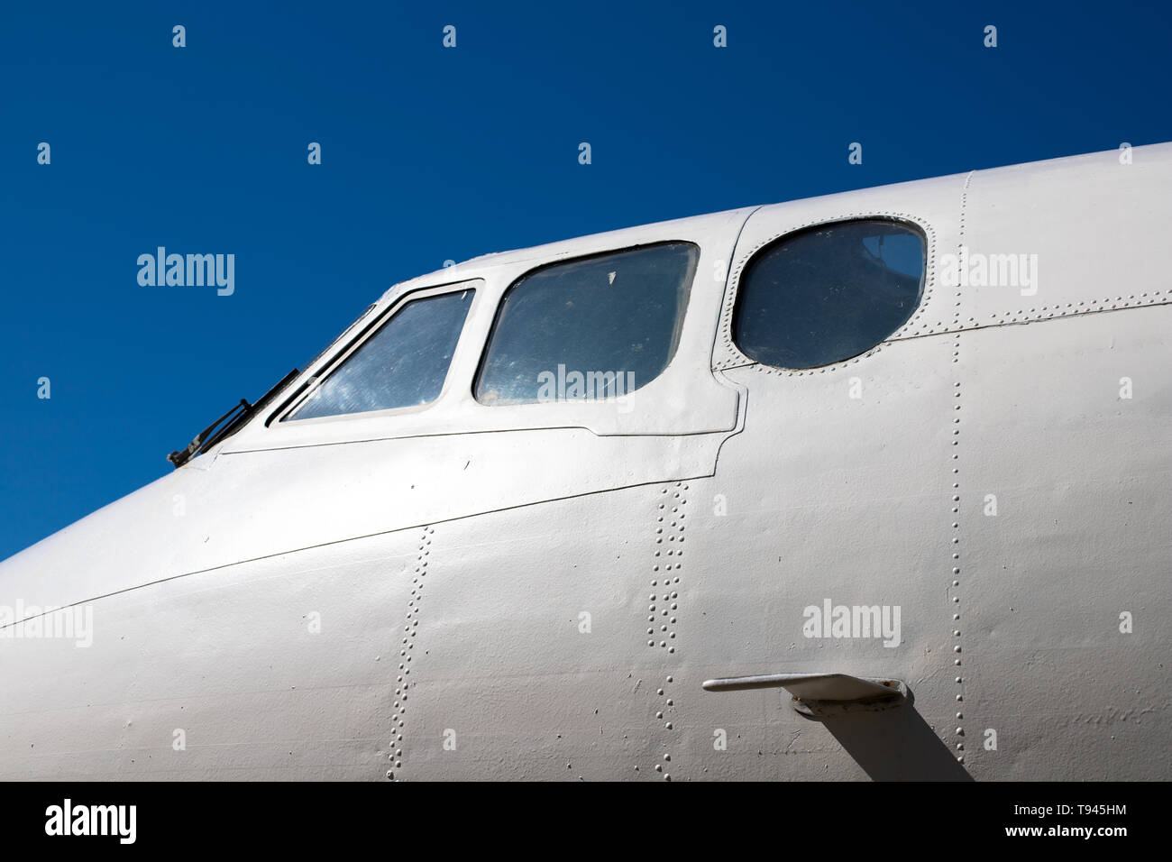Fuselage cockpit. Part of the aircraft. The nose of the aircraft against the blue sky. Stock Photo