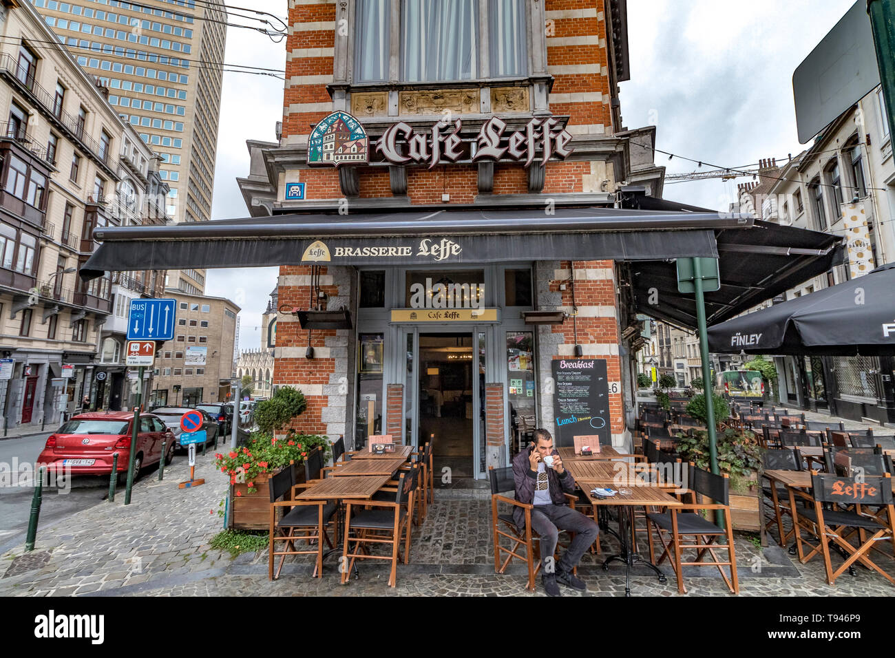 A man drinking a coffee sitting at the tables of Café Leffe, Place du Grand Sablon, the historic upper town of Brussels ,Belgium Stock Photo