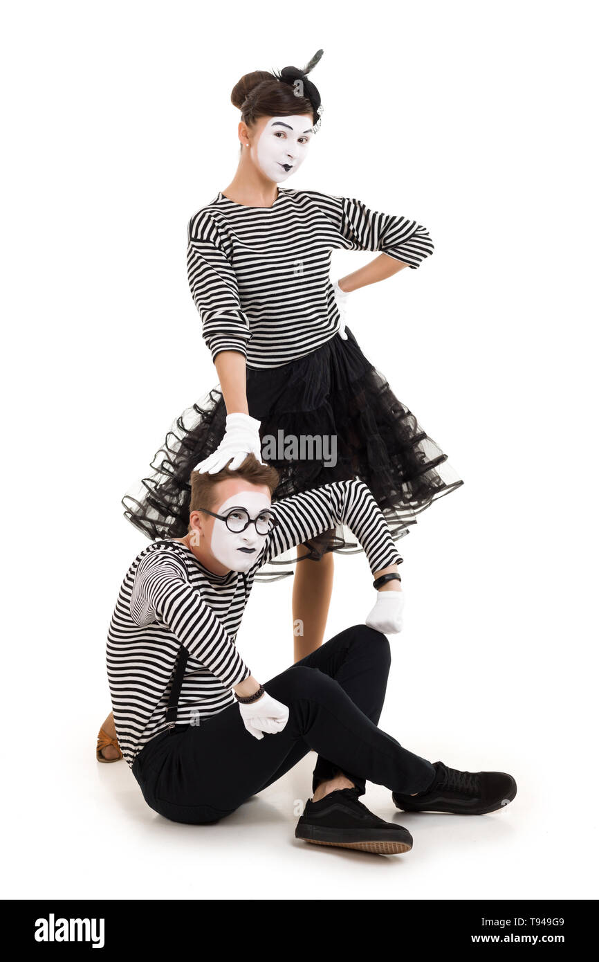 Smiling mimes in striped shirts. Man and woman dressed as actors of pantomime theater isolated on white background Stock Photo