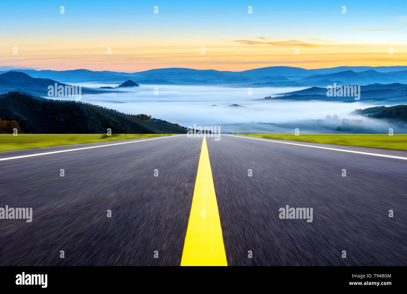 The highway leads to the distant mountains Stock Photo
