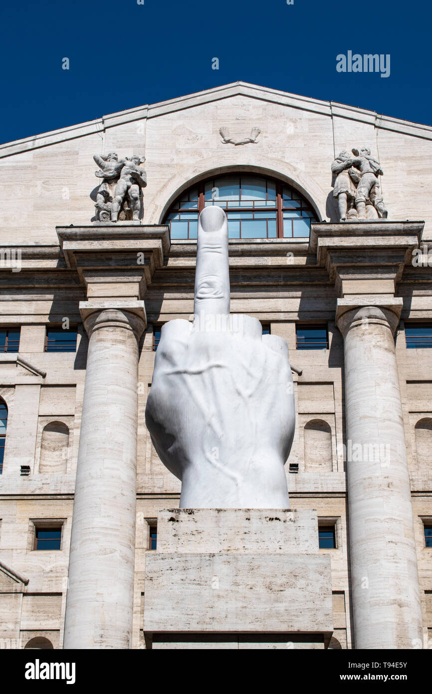 Milan, Italy: L.O.V.E. or The Finger, sculpture made by Maurizio Cattelan in front of Palazzo Mezzanotte, building housing is the Milan Stock Exchange Stock Photo