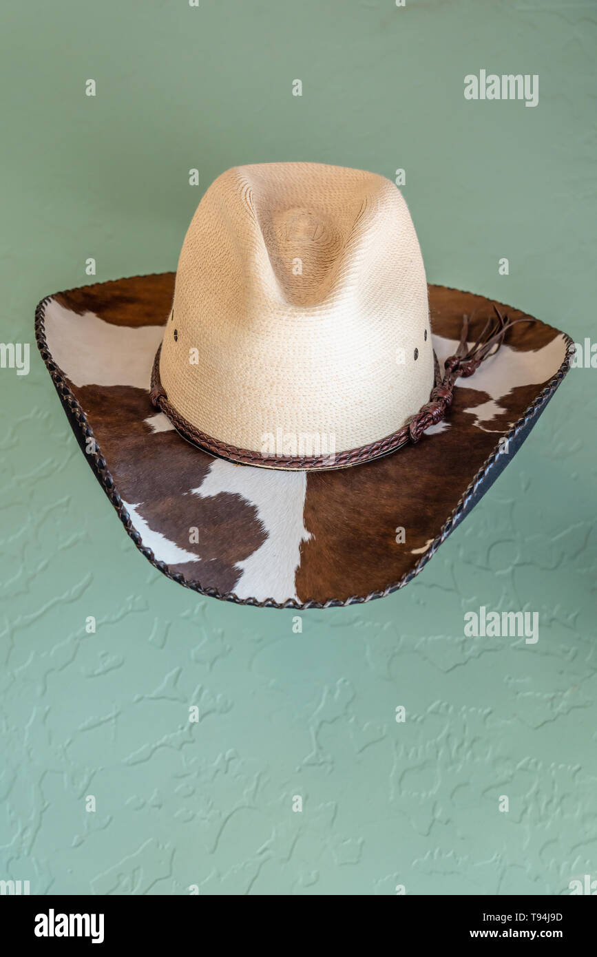western cowboy hat with hair on cowhide brim with leather whipstitch edge  and woven straw vented crown Stock Photo - Alamy