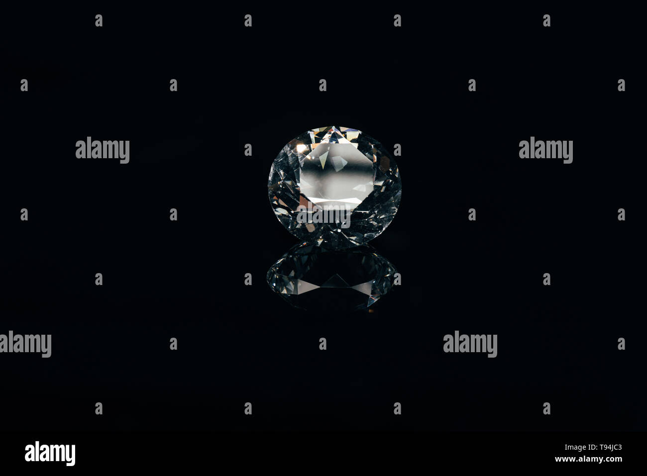 transparent pure sparkling diamond isolated on black with reflection ...