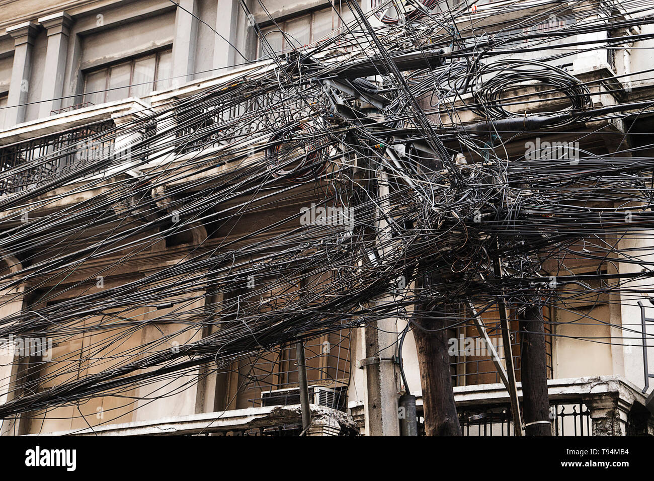 Tangled messy wiring on the streets of Asia Stock Photo