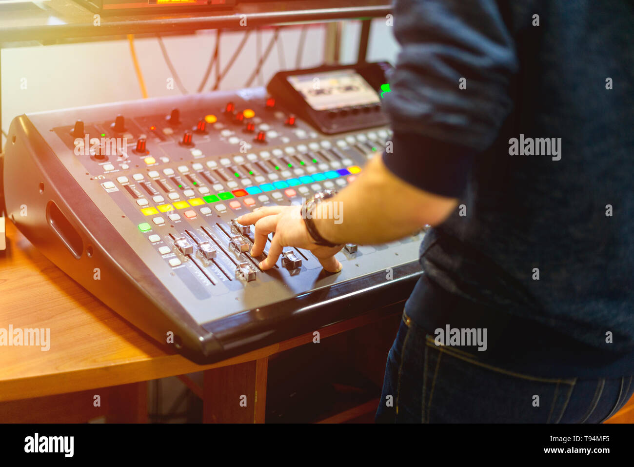 man using mixing console in sound recording studio Stock Photo