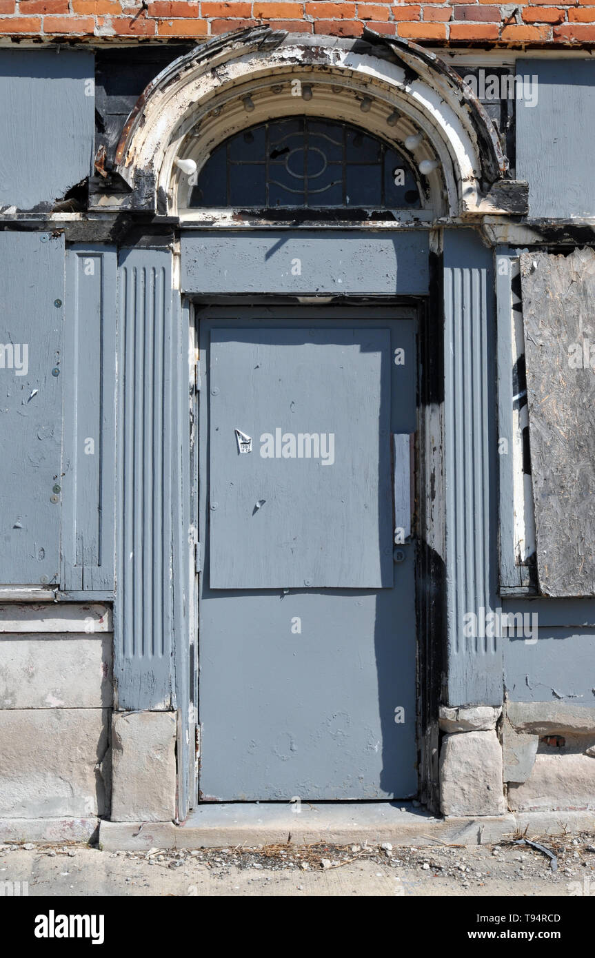 Detail of architectural features including a fanlight above the door to an abandoned commercial building in Detroit, Michigan. Stock Photo