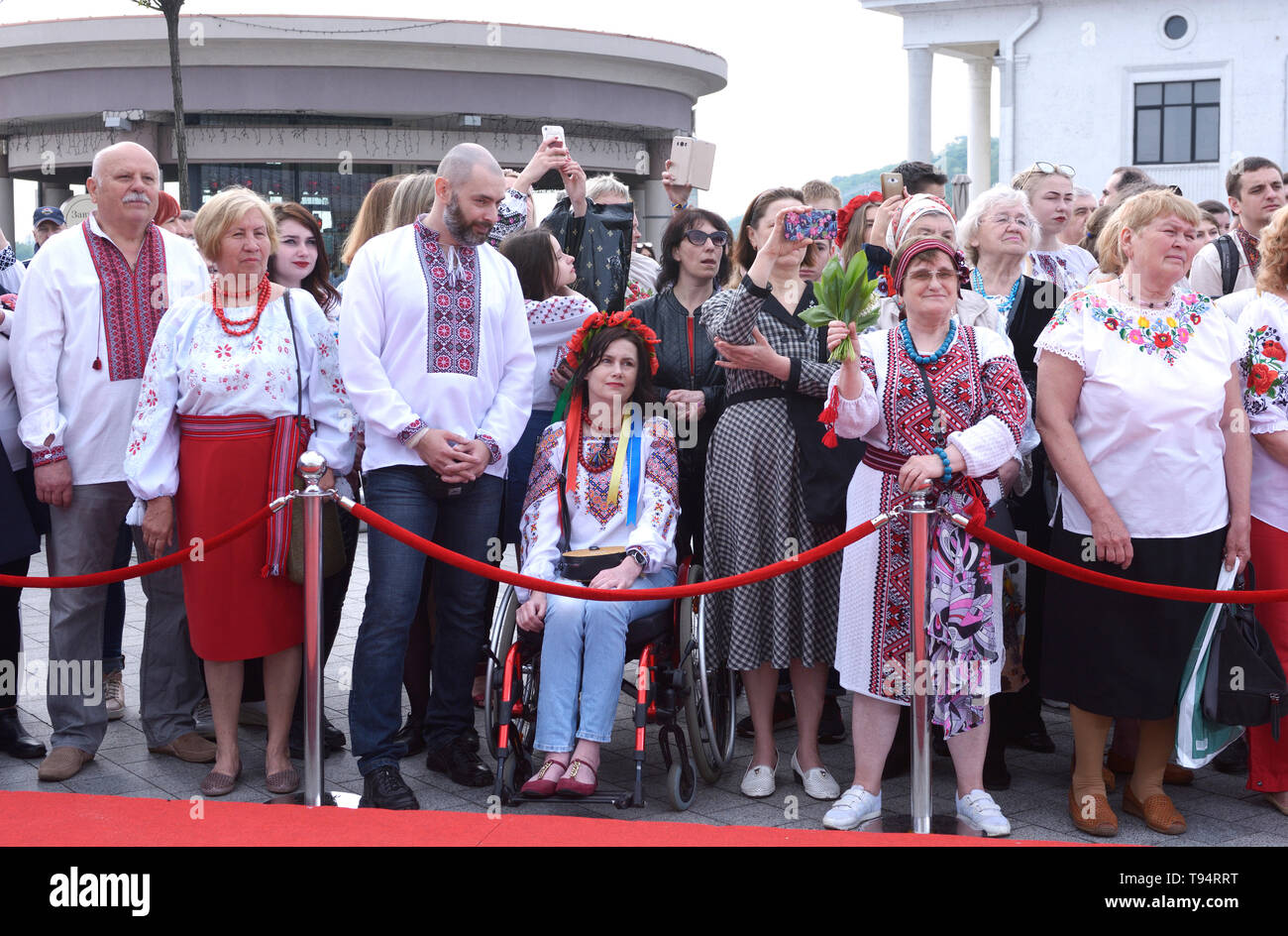 Group of people in Ukrainian embroidered shirts standing. Celebration