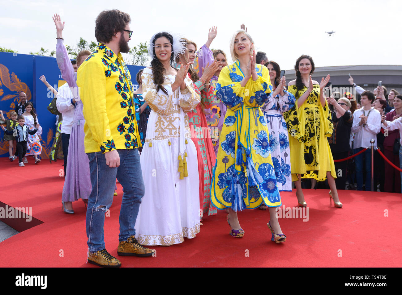 Group of people in Ukrainian embroidered shirts standing. Celebration