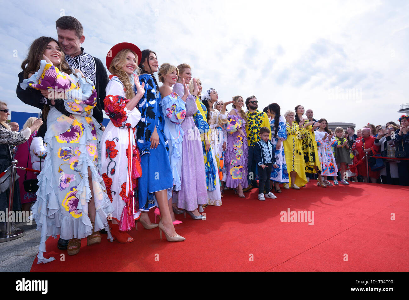 Group of people in Ukrainian embroidered shirts standing. Celebration