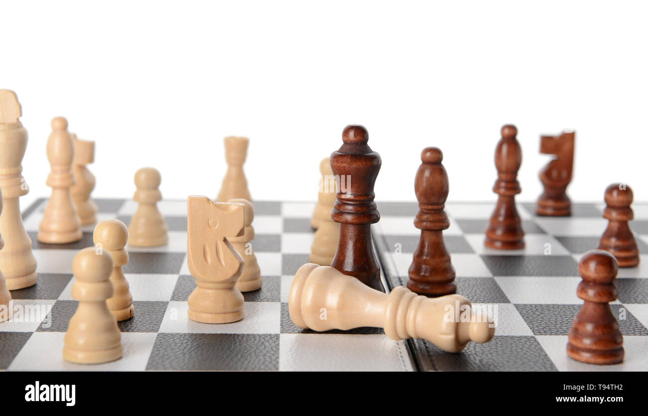 Chess pieces on game board against white background Stock Photo - Alamy