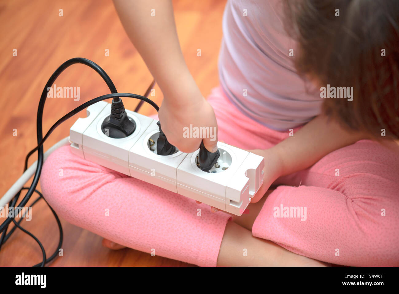 Little child playing with plug Stock Photo Alamy