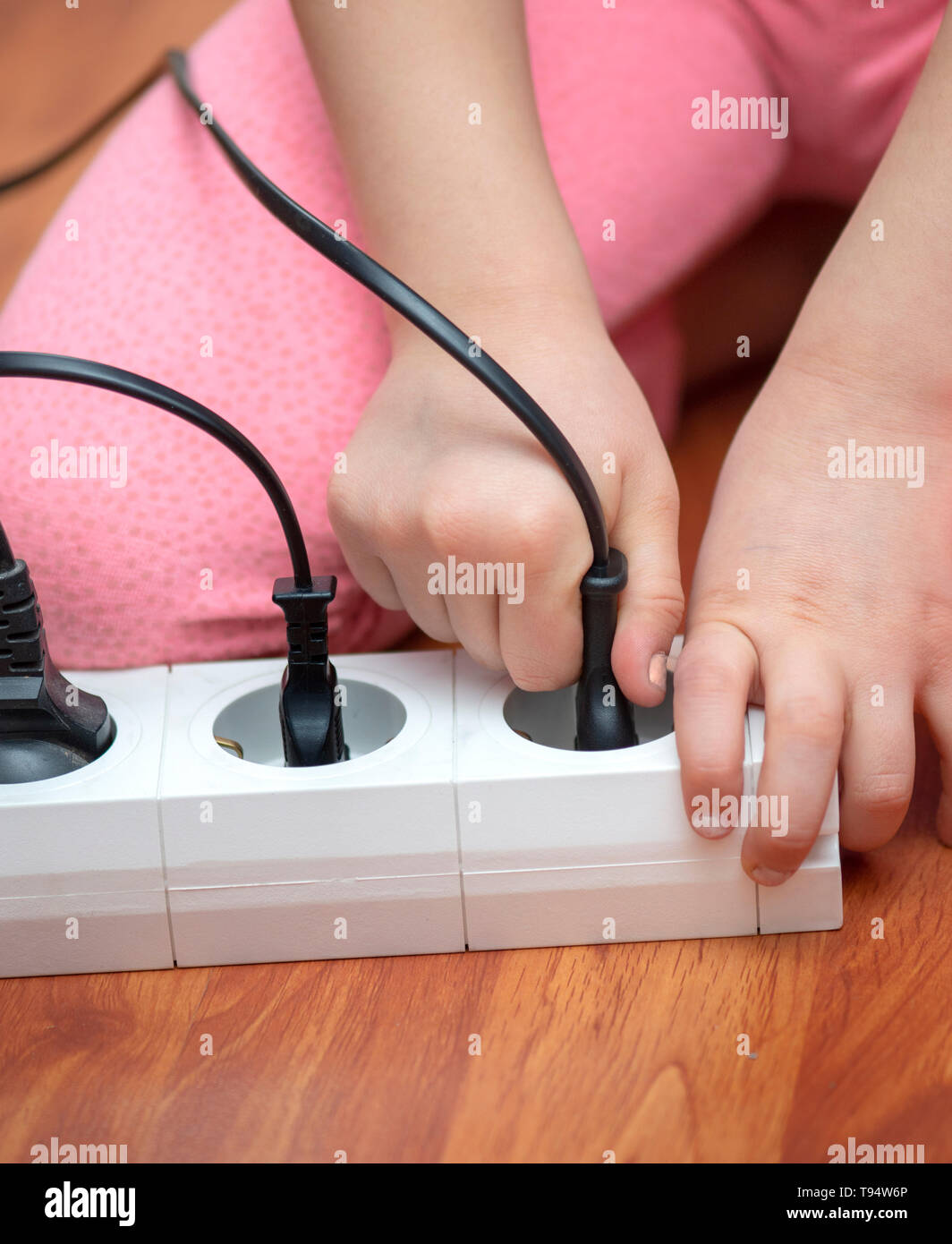Little child playing with plug Stock Photo Alamy