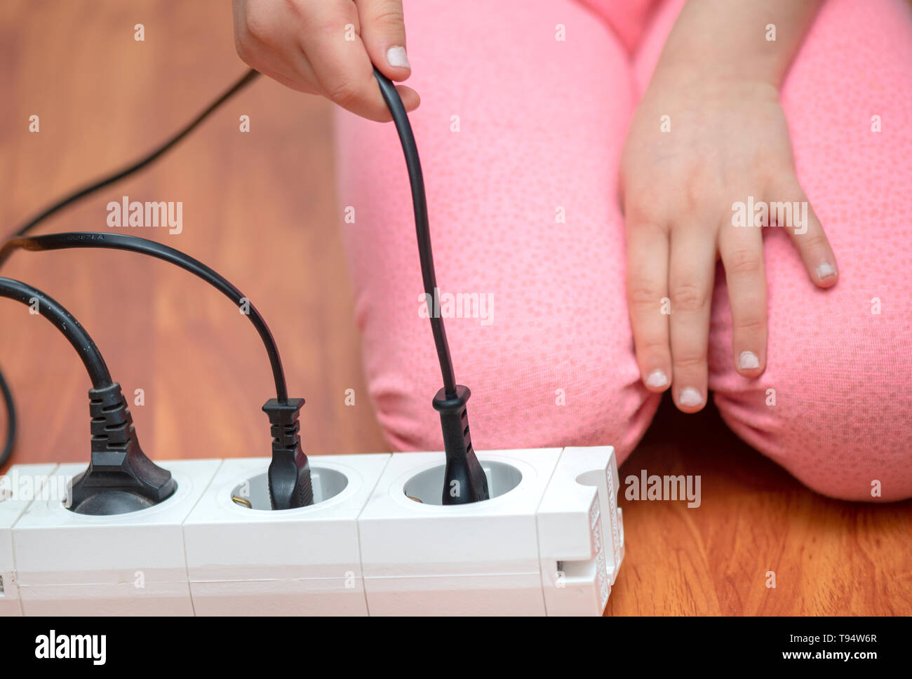 Little child playing with plug Stock Photo Alamy