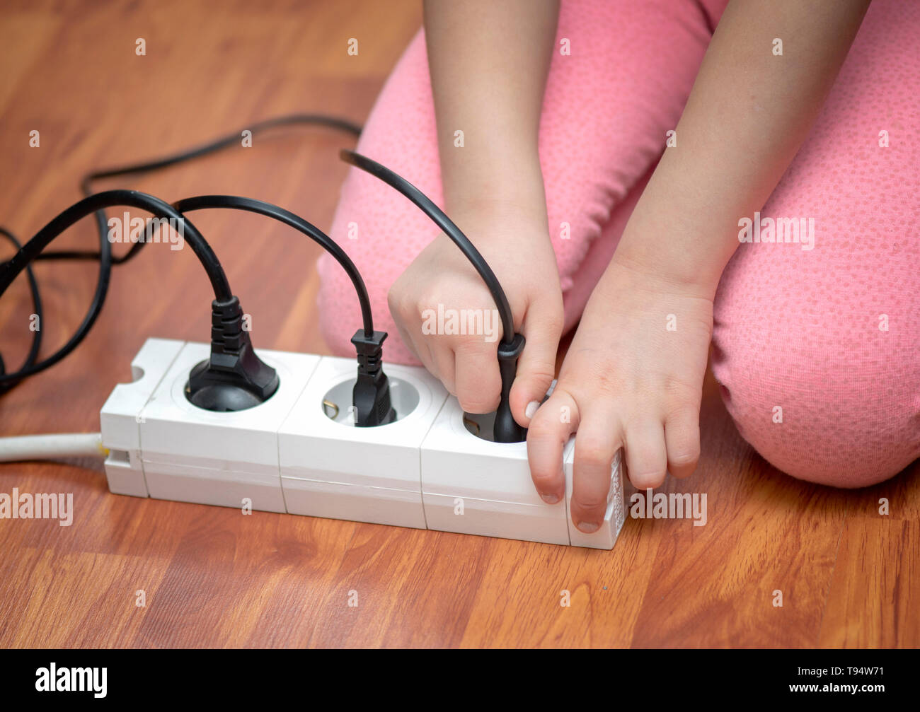 Little child playing with plug in the house Stock Photo Alamy