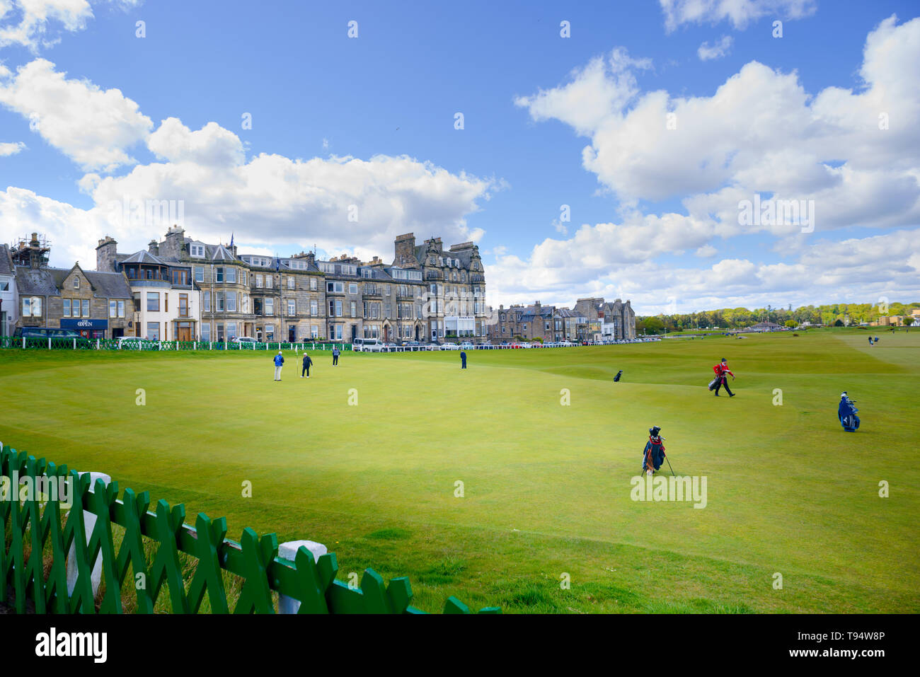 Golfers play the 18th green at the Royal and Ancient Golf Club of St