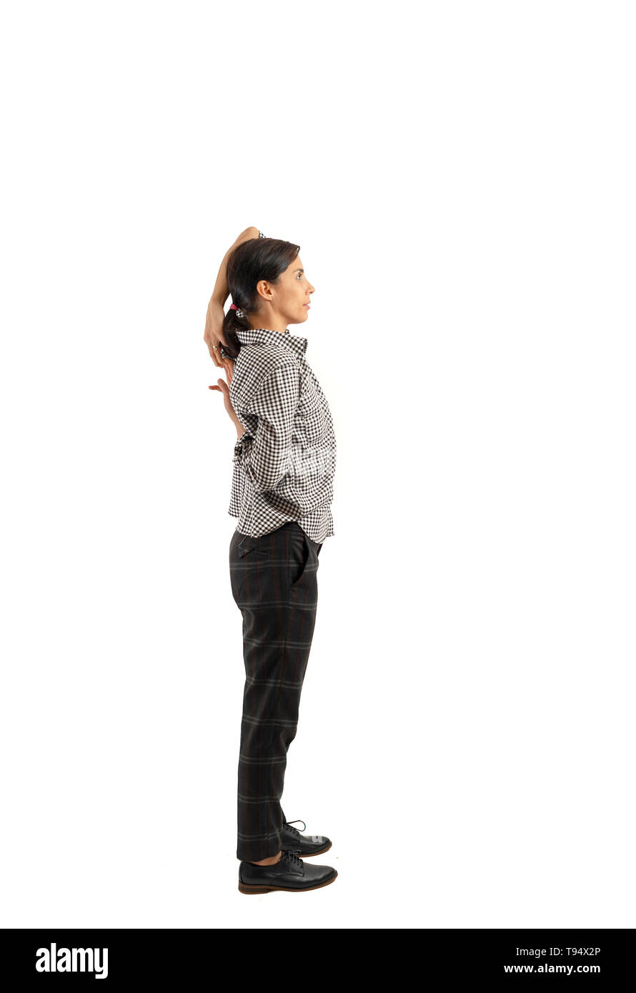 Young businesswoman isolated on white background doing exercises Stock Photo