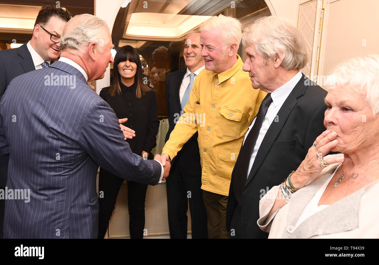 The Prince of Wales shakes hands with Chris Evans, watched by Claudia Winkleman (centre) and Dame Judi Dench and her partner David Mills at the annual Fortnum & Mason Food and Drink Awards at Fortnum & Mason, central London. Stock Photo