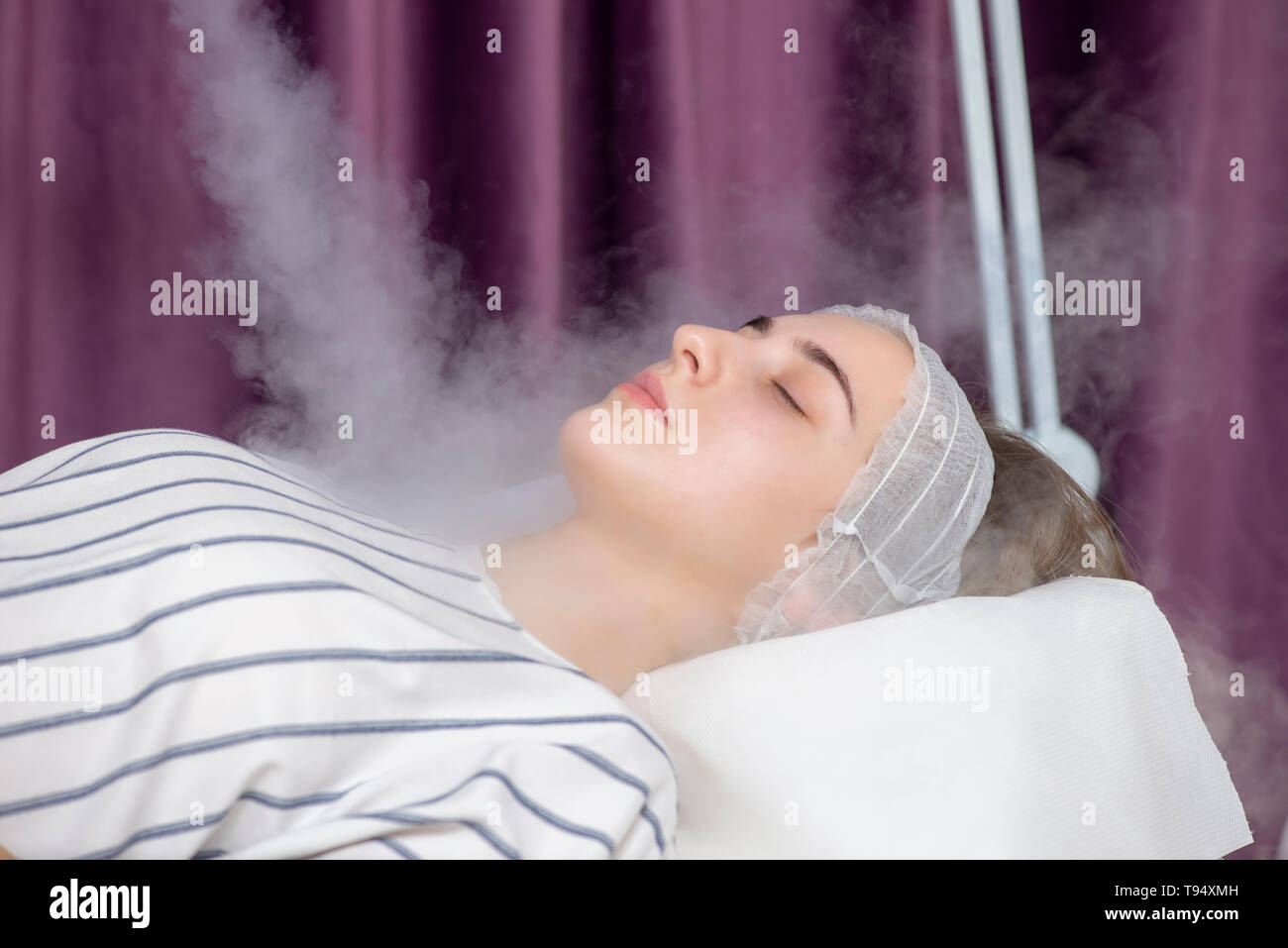 Beauty treatment of young female face, ozone facial steamer Stock Photo