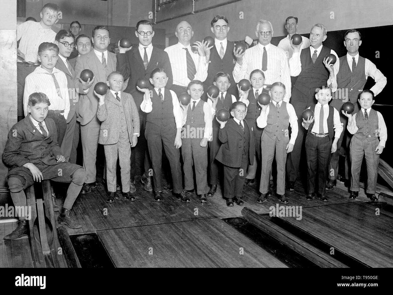 Entitled: 'Singer's Midgets Bowling at YMCA.' Singer's Midgets were a popular vaudeville group in the first half of the 20th century. Leopold von Singer (May 3, 1877 - March 5, 1951) formed Singer's Midgets in 1912-13, and built the Liliputstadt, a 'midget city' at the 'Venice in Vienna' amusement park, where they performed. The Liliputstadt was a major success, Singer began to tour with his performers throughout Europe and, in the process, recruited new members. Stock Photo