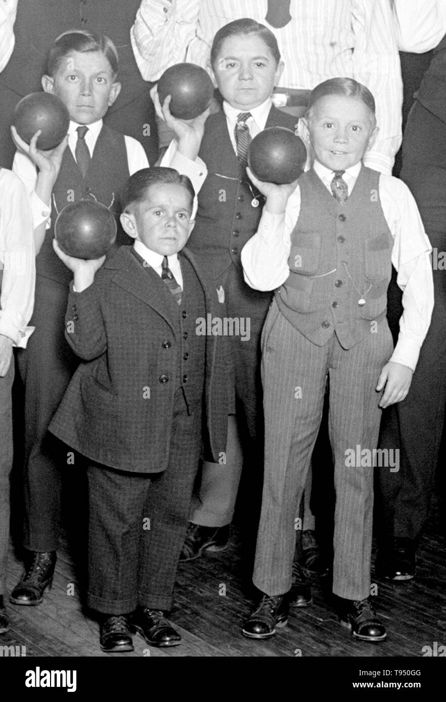 Entitled: 'Singer's Midgets Bowling at YMCA.' Singer's Midgets were a popular vaudeville group in the first half of the 20th century. Leopold von Singer (May 3, 1877 - March 5, 1951) formed Singer's Midgets in 1912-13, and built the Liliputstadt, a 'midget city' at the 'Venice in Vienna' amusement park, where they performed. The Liliputstadt was a major success, Singer began to tour with his performers throughout Europe and, in the process, recruited new members. Stock Photo