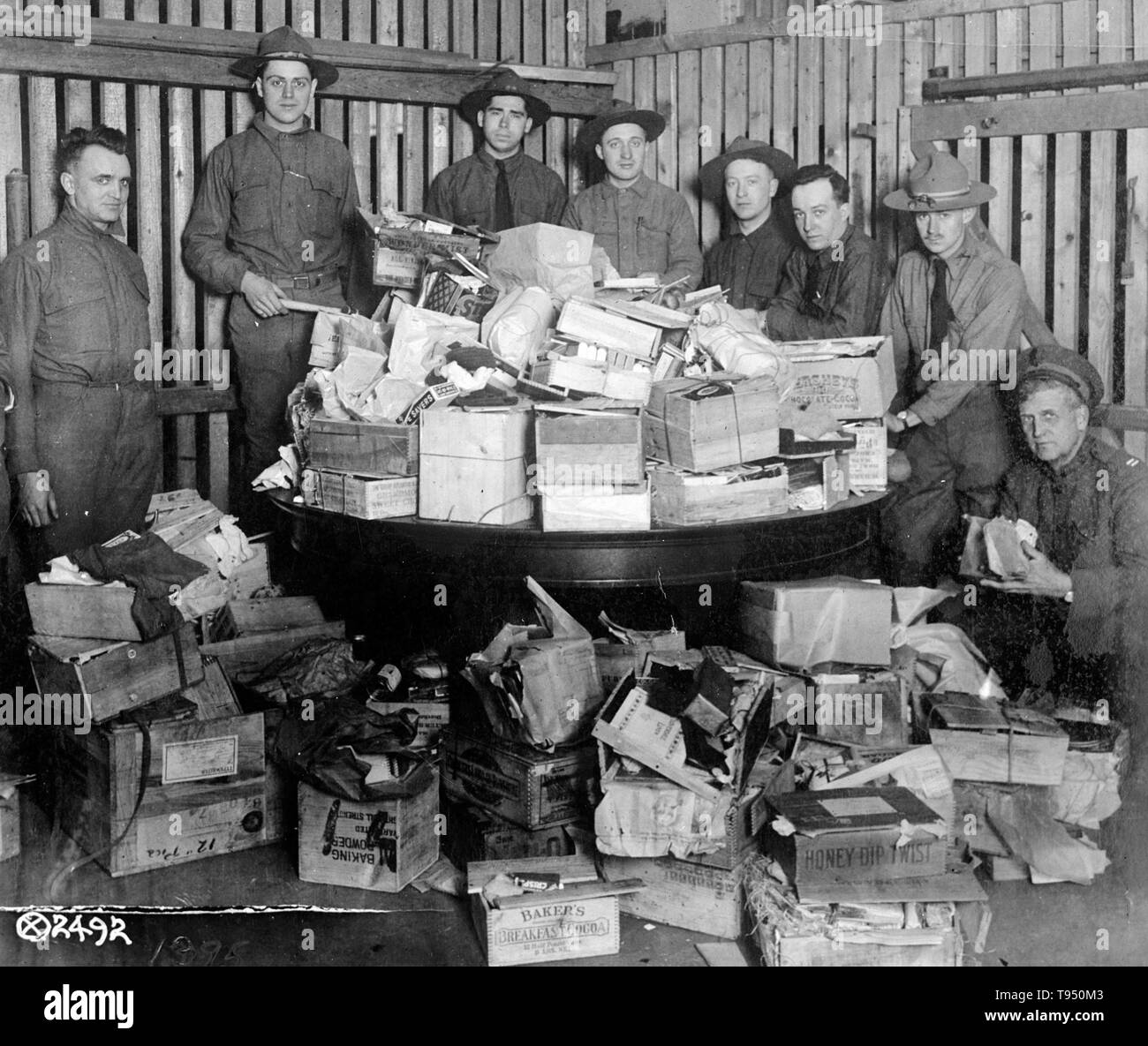 At the port of embarkation Army officers established a 'Christmas Box Hospital' for the repair of Christmas boxes received in the mails for shipment overseas to American soldiers in France. This photograph shows a pile of the damaged boxes awaiting inspection and repair. It was necessary to box anew about 11,000 christmas packages and many other packages were less seriously damaged in transit to the embarkation port. A total of 200,000 Christmas packages went to France from this country. Committee on Public Information, 1918. Stock Photo